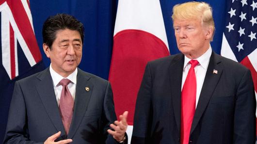 Japan's Prime Minister Shinzo Abe talks to US President Donald Trump during the opening ceremony of the 31st Association of Southeast Asian Nations (ASEAN) Summit in Manila on November 13, 2017.