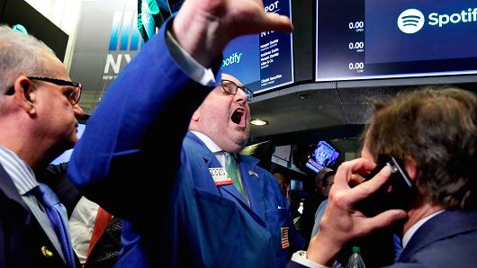 Specialist Peter Giacchi, center, declares Spotify's IPO open on the floor of the New York Stock Exchange, Tuesday, April 3, 2018.