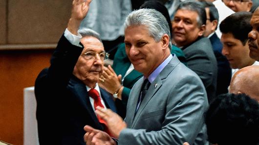 Cuban President Raul Castro (L) waves next to First Vice-President Miguel Diaz-Canel (C) during a National Assembly session that will select Cuba's Council of State ahead of the naming of a new president, in Havana on April 18, 2018.