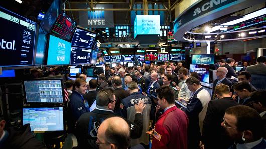 Traders work during the Pivotal Software Inc. initial public offering (IPO) on the floor of the New York Stock Exchange (NYSE) in New York, U.S., on Friday, April 20, 2018.