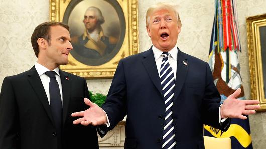 French President Emmanuel Macron (L) looks on as U.S. President Donald Trump speaks during their meeting in the Oval Office at the White House in Washington, April 24, 2018.