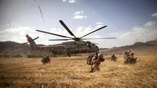 A Sikorsky helicopter lands near Marines with Fox Company, 2nd Battalion, 8th Marines, Regimental Combat Team 7, and Afghan National Security Forces provide security during Operation Nightmare in Nowzad, Afghanistan, June 6, 2013.