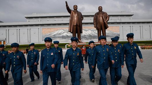 Pyongyang, April 15, 2018: Members of a North Korean youth league before the statues of late North Korean leaders Kim Il Sung and Kim Jong Il.