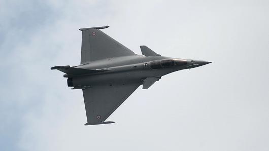 A French fighter jet, the Dassault Rafale, performs an aerial display.