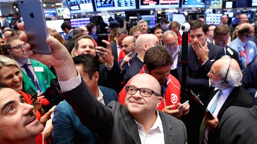 Jeff Lawson, (C) Founder, CEO, & Chairman of Communications software provider Twilio Inc., takes a selfie photo during his company's IPO on the floor of the New York Stock Exchange (NYSE) in New York City, U.S., June 23, 2016.