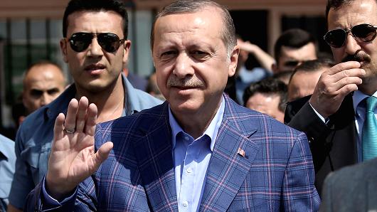 Turkish President Tayyip Erdogan greets his supporters as he leaves a polling station in Istanbul, Turkey April 16, 2017.