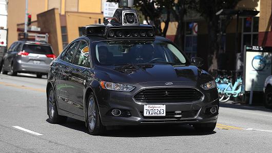 An Uber self-driving car drives down 5th Street on March 28, 2017 in San Francisco, California. Cars in Uber's self-driving cars are back on the roads after the program was temporarily halted following a crash in Tempe, Arizona on Friday.