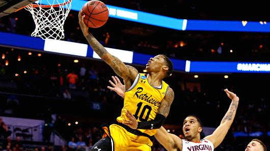 UMBC Retrievers guard Jairus Lyles (10) shoots the ball against Virginia Cavaliers forward Isaiah Wilkins (21) during the second half in the first round of the 2018 NCAA Tournament at Spectrum Center.