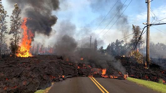 Lava from a fissure slowly advances to the northeast on Hookapu Street after the eruption of Hawaii's Kilauea volcano on May 5, 2018 in the Leilani Estates subdivision near Pahoa, Hawaii.