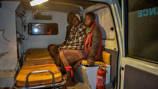 Local residents wait inside an ambulance after Patel dam burst its bank at Solai, about 40 kilometres north of Nakuru, Kenya, on May 9, 2018.