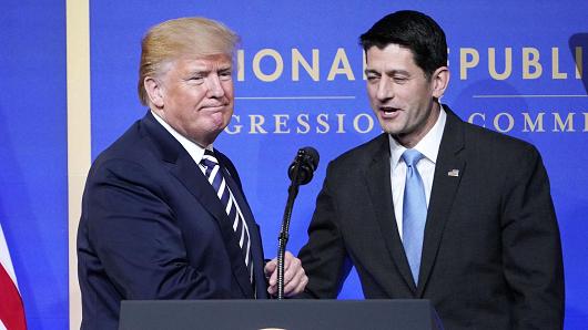 House Speaks Paul Ryan greets US President Donald Trump as he arrives on stage to speak at the National Republican Congressional Committee March Dinner at the National Building Museum on March 20, 2018 in Washington, DC.