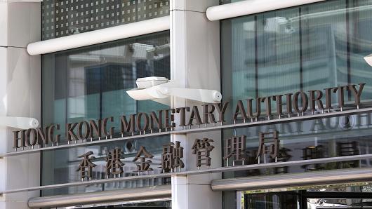The Hong Kong Monetary Authority is displayed outside Two International Finance Centre in Hong Kong on June 19, 2013.