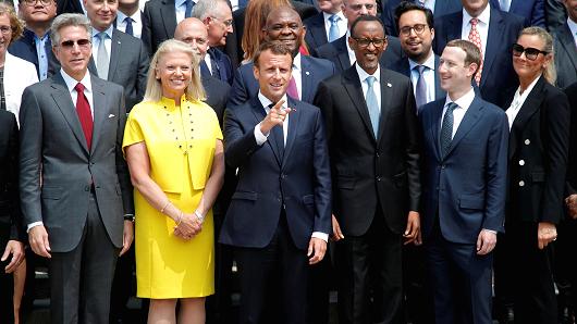 French President Emmanuel Macron (C) poses for a family picture with Rwanda's President Paul Kagame (3rdR), Facebook's founder and CEO Mark Zuckerberg (2ndR) and IMB's President and CEO Ginni Rometty (2ndL) as he hosts the 'Tech for Good' summit over lunch with tech companies CEOs at the Elysee Palace in Paris, on May 23, 2018.