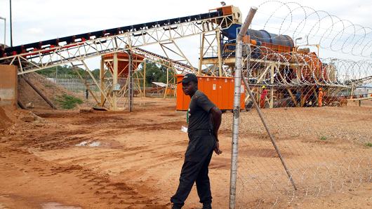 A private security employee guards a diamond processing plant in Zimbabwe's eastern Marange region on December 14, 2011.