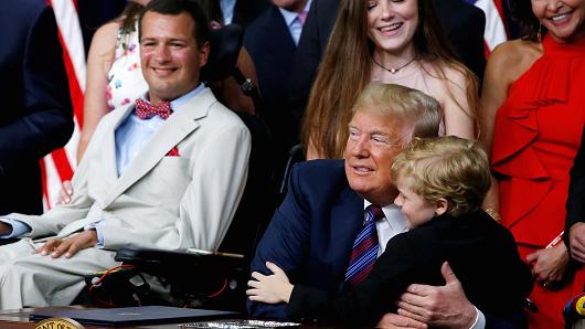 Seven-year-old Muscular Dystrophy patient Jordan McLinn, from Indiana, is embraced by U.S. President Donald Trump during the president's signing of the "Right to Try Act," which gives terminally ill patients the right to use experimental medications not yet been approved by the Food and Drug Administration (FDA), at the White House in Washington, U.S., May 30, 2018.