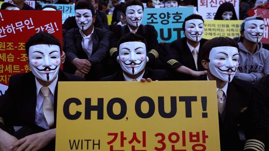 Korean Air pilots, cabin crew and activists, many wearing Guy Fawkes masks, attend a rally on May 4, 2018 in Seoul, South Korea.