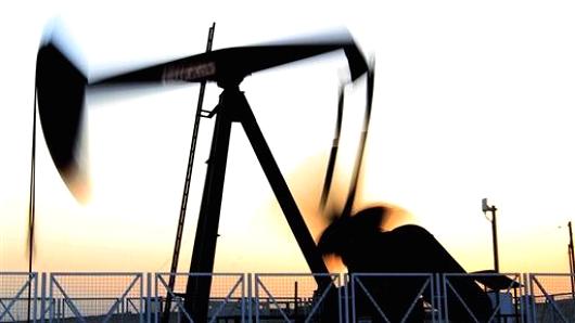 An oil pump works in the Sakhir, Bahrain, desert oil fields at sunset Tuesday, July 3, 2012. The price of oil jumped more than 4 percent Tuesday to the highest level since May on renewed fears of a military conflict with Iran. (AP Photo/Hasan Jamali)