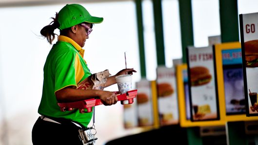 An employee delivers food at a Sonic drive-in restaurant in Normal, Illinois.