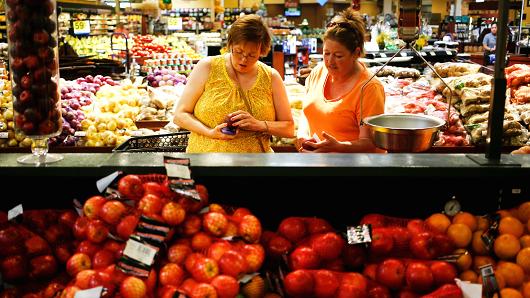 Customers shop the produce aisle at a Kroger grocery store in Louisville, Kentucky.