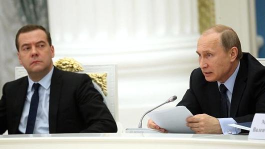 Russian President Vladimir Putin (R) and Prime Minister Dmitry Medvedev (L) attend a meeting in Moscow in May 2015.