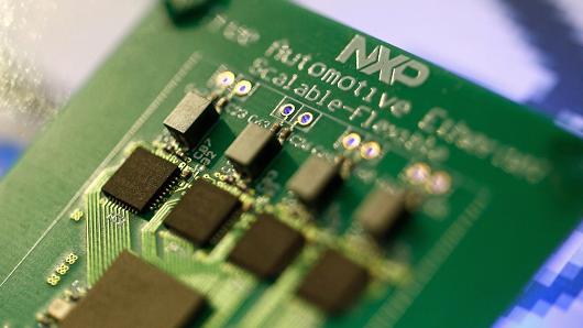 Microprocessors sit on a circuit board labelled 'true Automotive Ethernet' at the NXP Semiconductors NV pavilion at the Mobile World Congress in Barcelona, Spain.