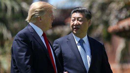 President Donald Trump and China's President Xi Jinping chat as they walk along the front patio of the Mar-a-Lago estate after a bilateral meeting in Palm Beach, Florida, U.S., April 7, 2017.