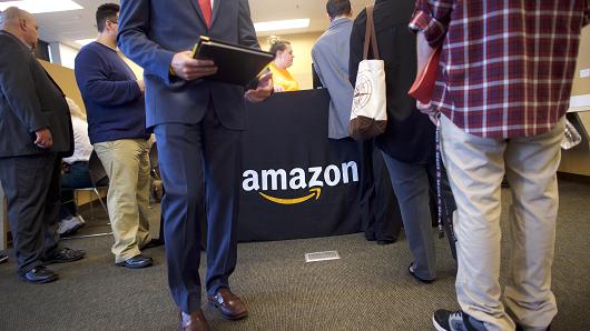Job seekers register before interviews during an Amazon jobs fair at the Amazon Fulfillment Center on August 2, 2017 in Robbinsville, New Jersey.