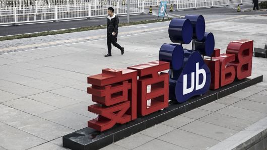 A man walks past a sign for Baidu Inc. at the entrance to the Baidu Technology Park in Beijing, China, on Friday, Nov. 25, 2016.