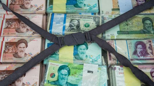 A briefcase filled with Iranian rial banknotes sits on display at a currency exchange market on Ferdowsi street in Tehran, Iran, on Saturday, Jan. 6, 2018.