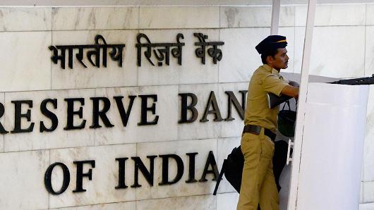 An Indian policeman stands guard at the entrance of the Reserve Bank of India (RBI) head office in Mumbai on October 4, 2017.