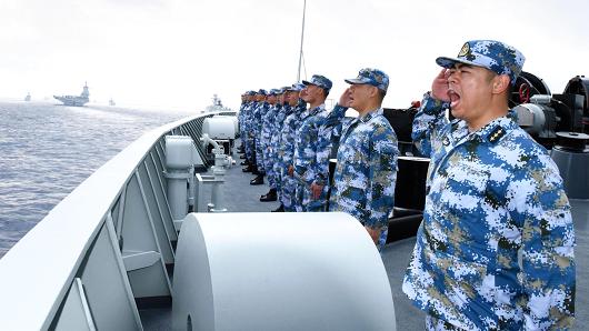 A PLA Navy fleet including the aircraft carrier Liaoning, submarines, vessels and fighter jets take part in a review in the South China Sea last April.