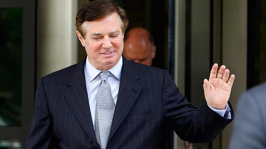 Paul Manafort, former campaign manager for Donald Trump, waves while exiting federal court in Washington, D.C.
