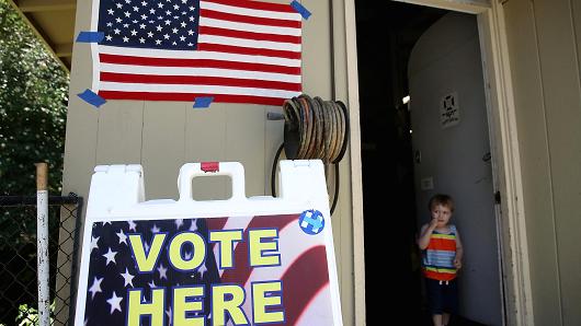 A boy stands in the doorway of a polling station on June 5, 2018 in San Anselmo, California. California voters are heading to the polls to vote in the primary election.
