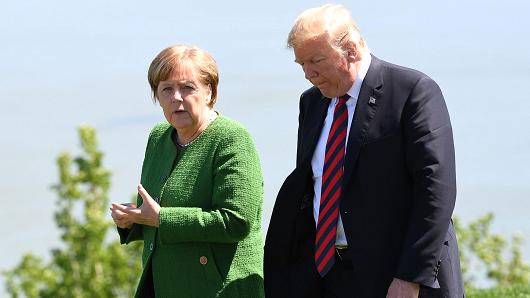 (L-R) German Chancellor Angela Merkel and US President Donald Trump speaks after a family photo during the G7 Summit in in La Malbaie, Quebec, Canada, June 8, 2018.