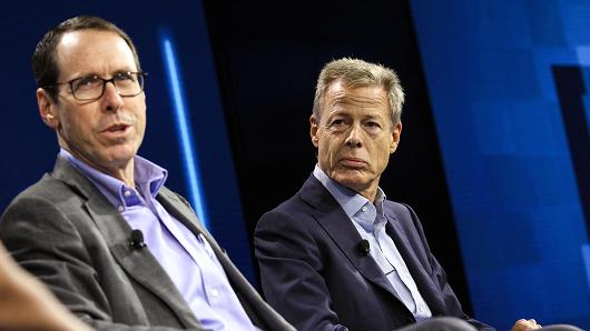 Randall Stephenson, chairman and chief executive officer of AT&T Inc., left, speaks while Jeffrey 'Jeff' Bewkes, chairman and chief executive officer of Time Warner Inc.
