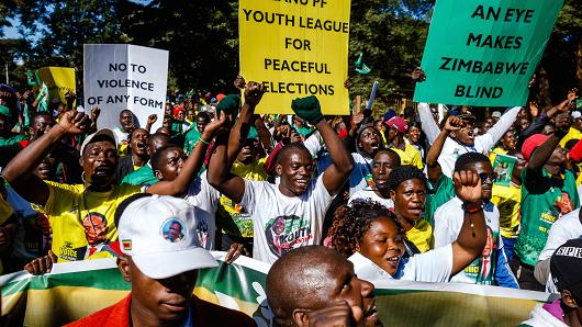 Activists from Zimbabwe's ruling party Zimbabwe African National Union Patriotic Front (ZANU PF) Youth League march for peace ahead of the July 30 general elections on June 6, 2018, in Harare, Zimbabwe.