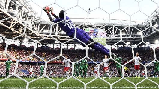 Senegal's goalkeeper Khadim N'Diaye stops the ball after Poland's forward Robert Lewandowski (rear C) shot a free kick during the Russia 2018 World Cup Group H football match between Poland and Senegal at the Spartak Stadium in Moscow on June 19, 2018.