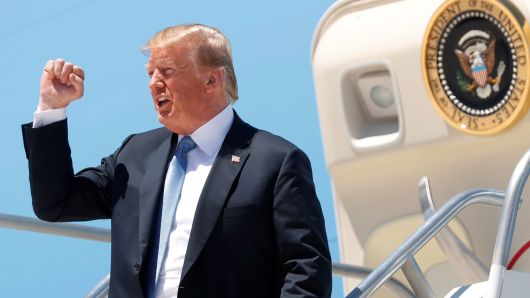 President Donald Trump pumps his fist as he steps from Air Force One upon arrival in Las Vegas, Nevada, June 23, 2018. 