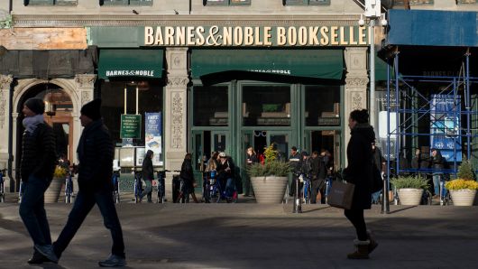 Pedestrians pass in front of a Barnes and Noble Inc. store in New York, Nov. 24, 2013.