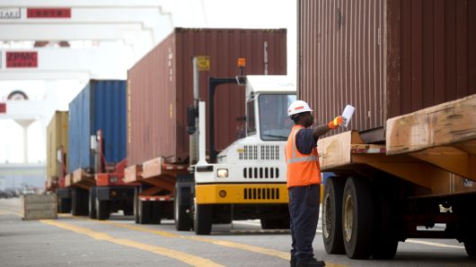 A spotter lines up a truck before a container is loaded a ship in the Seagirt Marine Terminal at the Port of Baltimore in Baltimore, Maryland.