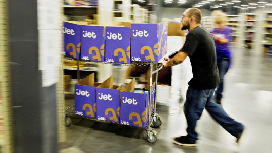 Employees collect items for customer orders at the Jet.com Inc. fulfillment center on Cyber Monday in Kansas City, Kansas.