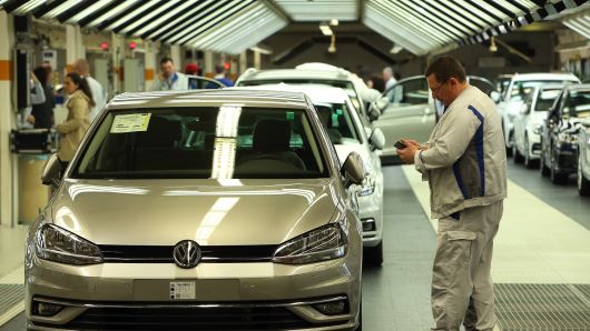 An employee performs the final inspection of a Golf 7 automobile at the Volkswagen in Wolfsburg, Germany.