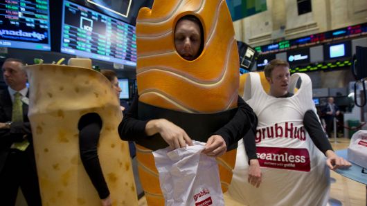 Actors dressed in Grubhub Inc. costumes interact with traders on the floor of the New York Stock Exchange (NYSE) in New York.