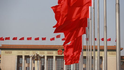 Flags fly in front of the Great Hall of the People in Beijing, China, on March 5, 2018.
