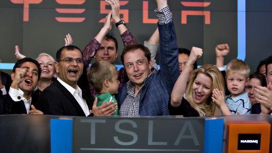 Elon Musk, chairman and chief executive officer of Tesla Motors, center, participates in the opening bell ceremony at the Nasdaq Marketsite with his twin boys Griffin, green shirt at center, and Xavier, right in blue shirt, and his fiancee (at the time) Talulah Riley, second from right, in New York, U.S., on Tuesday, June 29, 2010.