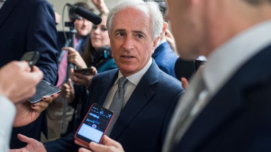 Sen. Bob Corker, R-Tenn., talks with reporters in the Capitol's Senate subway before the Senate Policy luncheons on June 19, 2018. 