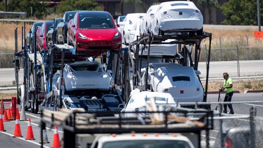Tesla vehicles are loaded onto a truck for transport at the company's manufacturing facility in Fremont, California, on Wednesday, June 20, 2018. 