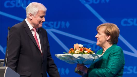 Chancellor Angela Merkel receives flowers by CSU leader Horst Seehofer on December 15, 2017 in Nuremberg, Germany. 