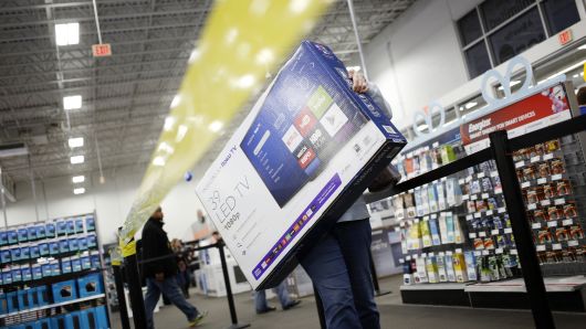 A shopper carries an Insignia Roku TV television at a Best Buy Co. store in Louisville, Kentucky, U.S., 