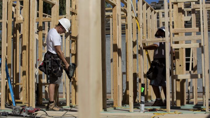 Contractors work on the frame of a home under construction at the D.R. Horton Express Homes Magma Ranch housing development in Florence, Arizona.  